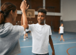 Student high fives PE teacher.